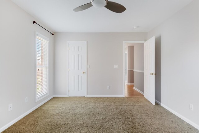 unfurnished bedroom with carpet floors, ceiling fan, and baseboards