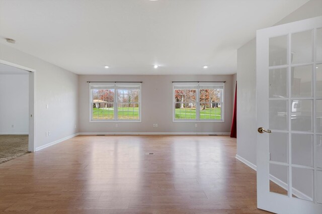 unfurnished room featuring recessed lighting, light wood-style flooring, and baseboards