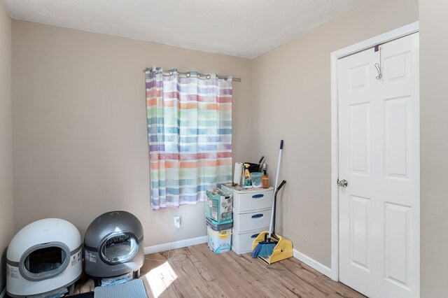 misc room with light wood-type flooring and baseboards