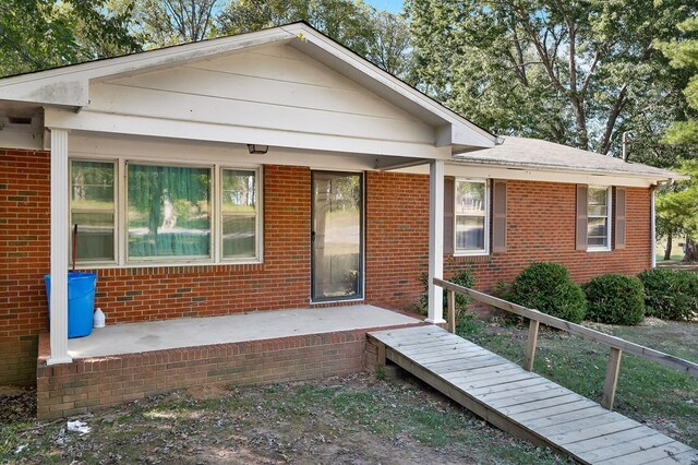 view of front facade with a patio and brick siding