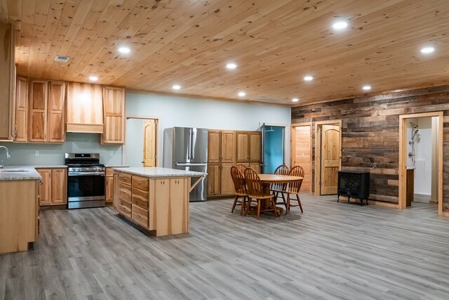 kitchen featuring stainless steel appliances, premium range hood, wood ceiling, light countertops, and a center island