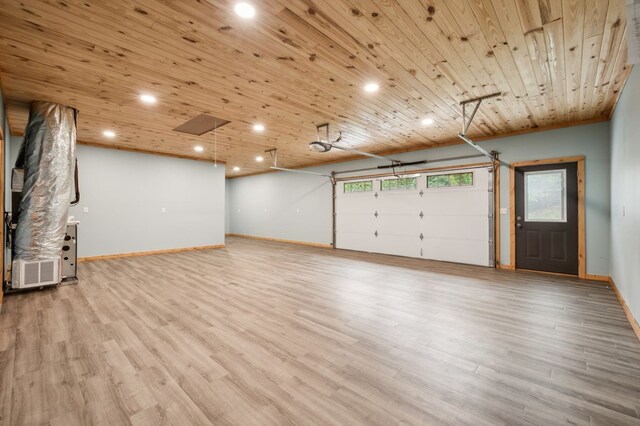 garage featuring recessed lighting, wood ceiling, and baseboards