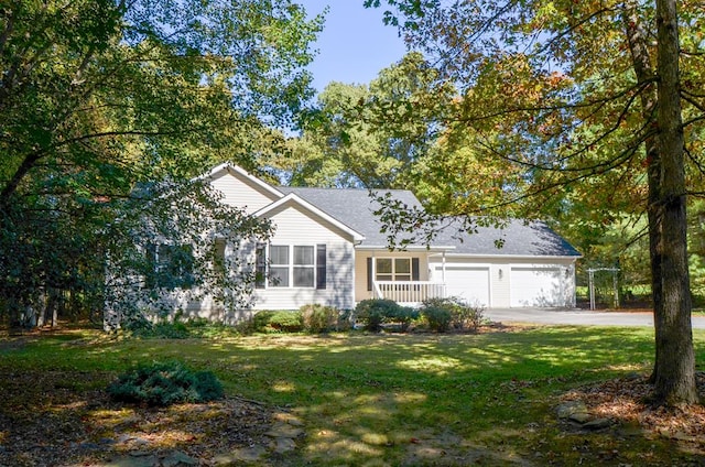 ranch-style home featuring an attached garage, driveway, and a front lawn