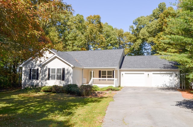 single story home featuring a garage, aphalt driveway, a porch, and a front yard