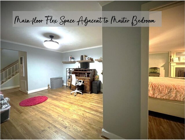 home office with ornamental molding, a fireplace, wood finished floors, and baseboards