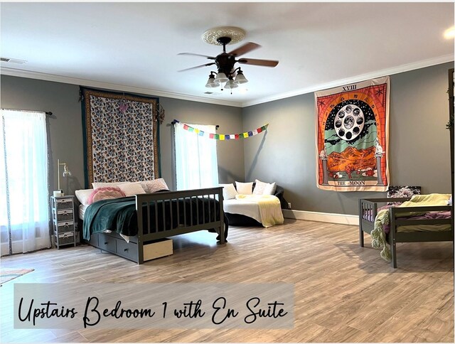 bedroom featuring visible vents, crown molding, baseboards, and wood finished floors