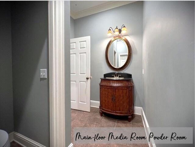 half bath featuring ornamental molding, tile patterned floors, vanity, and baseboards