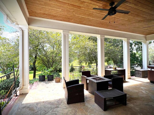 view of patio / terrace featuring ceiling fan and an outdoor fire pit