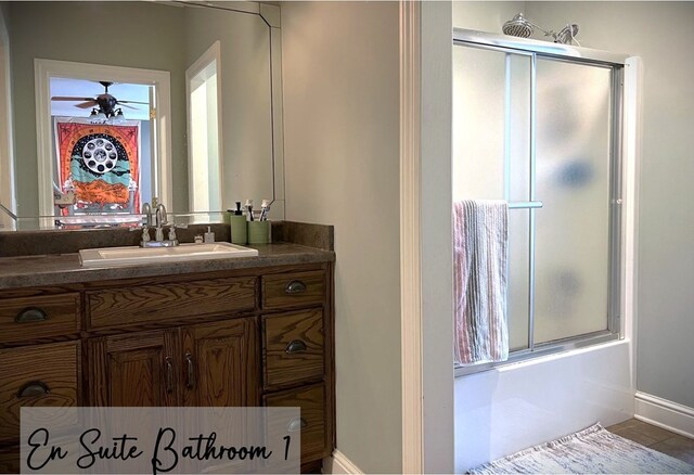 bathroom featuring tile patterned flooring, enclosed tub / shower combo, ceiling fan, and vanity