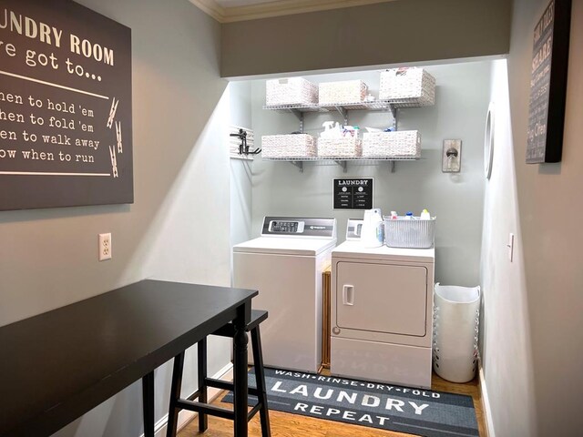 laundry room with washing machine and dryer, laundry area, and wood finished floors