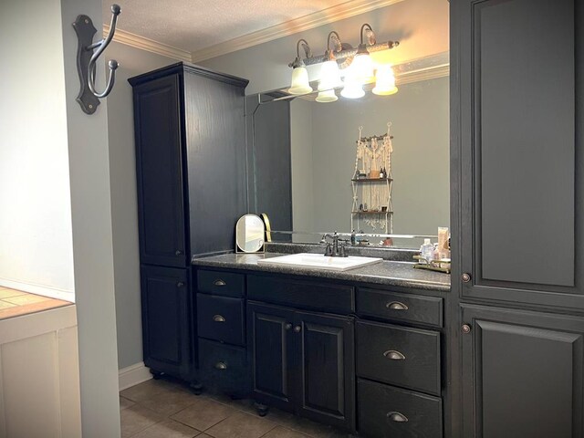 bathroom featuring vanity, crown molding, and tile patterned floors