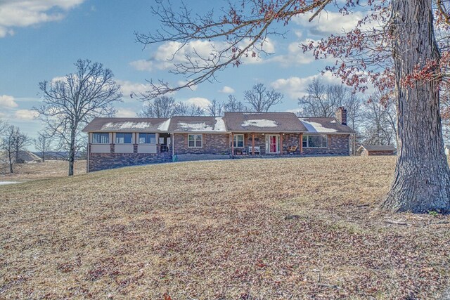 single story home featuring a front yard and a chimney