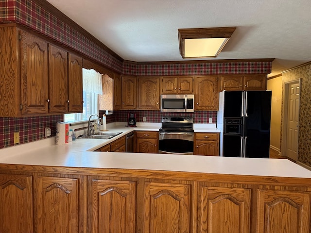 kitchen with a sink, backsplash, stainless steel appliances, a peninsula, and light countertops