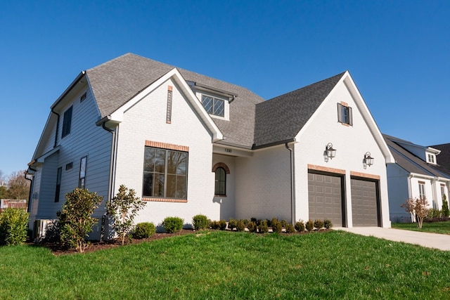 view of front facade featuring driveway, brick siding, roof with shingles, and a front yard