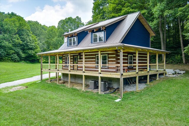 exterior space with metal roof and central AC