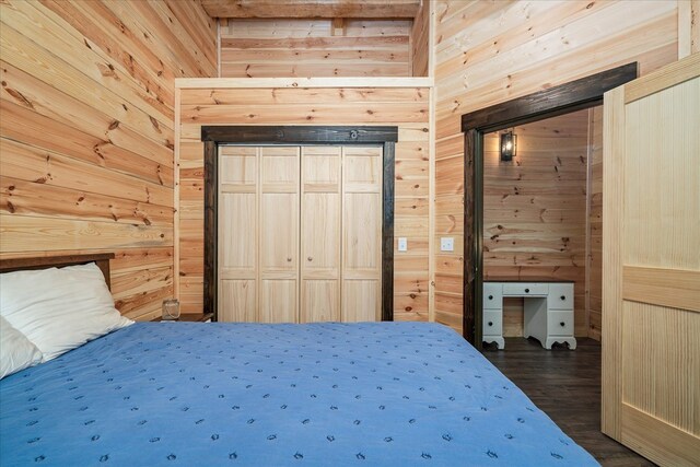 unfurnished bedroom with dark wood-style flooring and wood walls