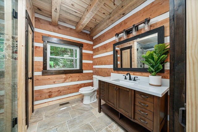 bathroom featuring stone tile flooring, visible vents, toilet, wooden walls, and vanity