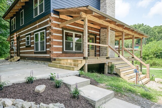 exterior space with covered porch and a chimney