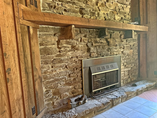 details featuring heating unit and a glass covered fireplace