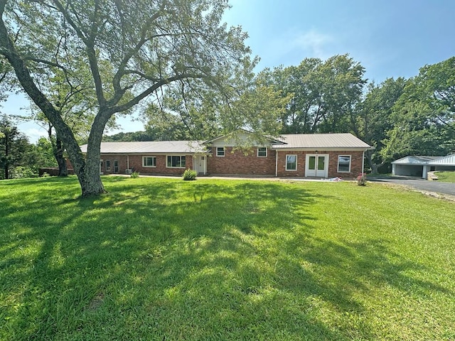 ranch-style house with brick siding, aphalt driveway, and a front lawn