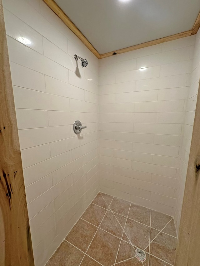 full bath with tile patterned floors and tiled shower