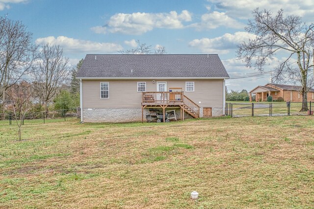 rear view of house featuring stairs, a deck, a lawn, and a fenced backyard