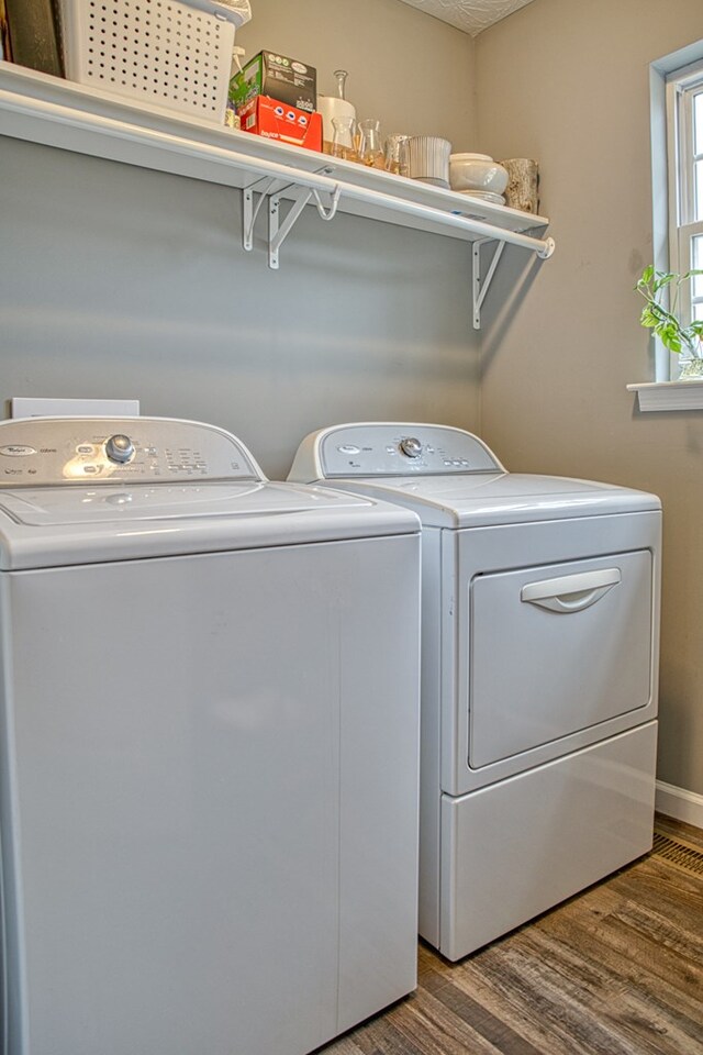 washroom featuring a textured ceiling, laundry area, washer and clothes dryer, and wood finished floors