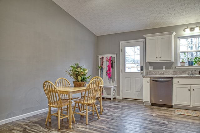 dining area with dark wood-style floors, plenty of natural light, baseboards, and vaulted ceiling