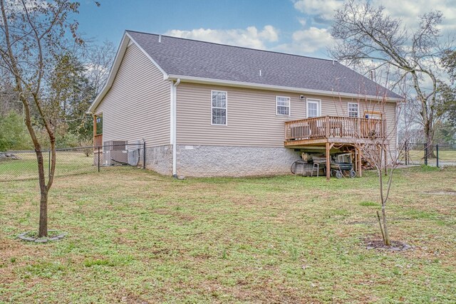 back of house featuring a fenced backyard, a deck, cooling unit, and a yard