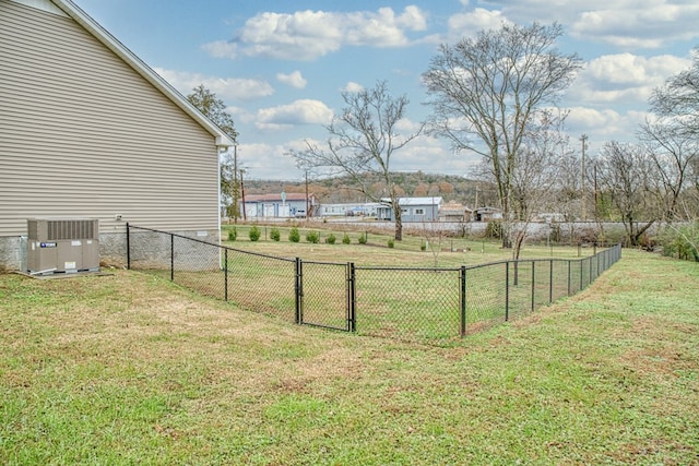 view of yard featuring fence and central air condition unit