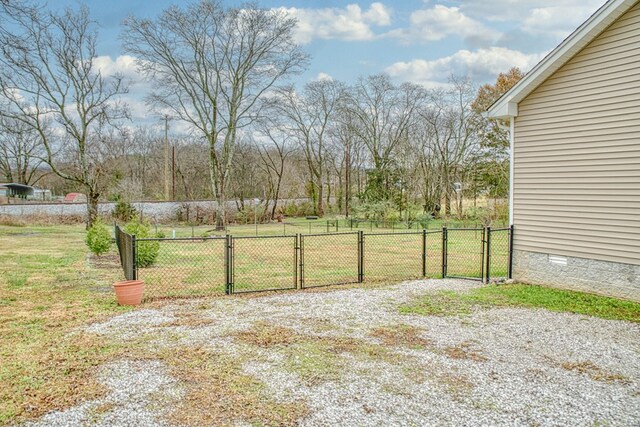 view of yard featuring fence and a gate