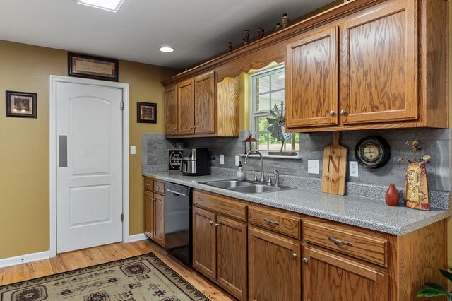 kitchen featuring a sink, light countertops, brown cabinets, decorative backsplash, and dishwasher