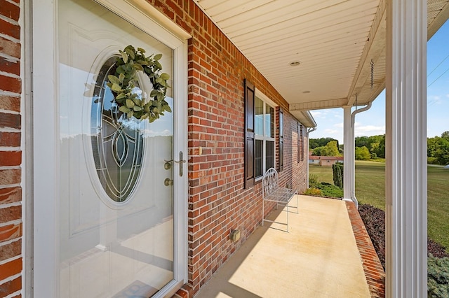 entrance to property featuring brick siding