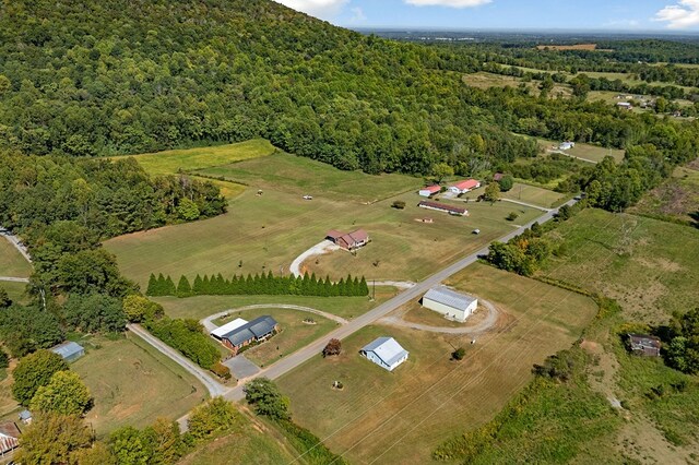 birds eye view of property with a wooded view and a rural view