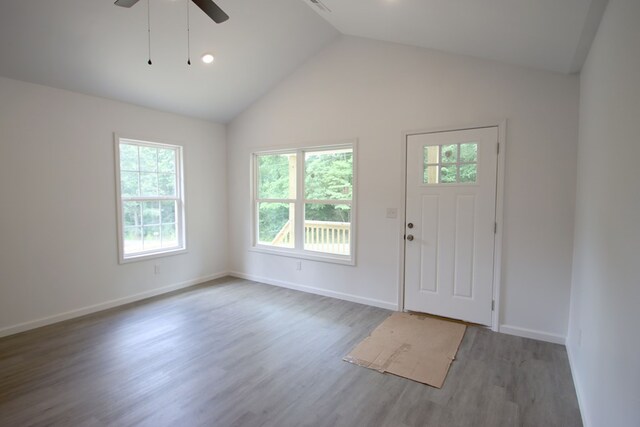 entrance foyer featuring lofted ceiling, wood finished floors, a ceiling fan, and baseboards