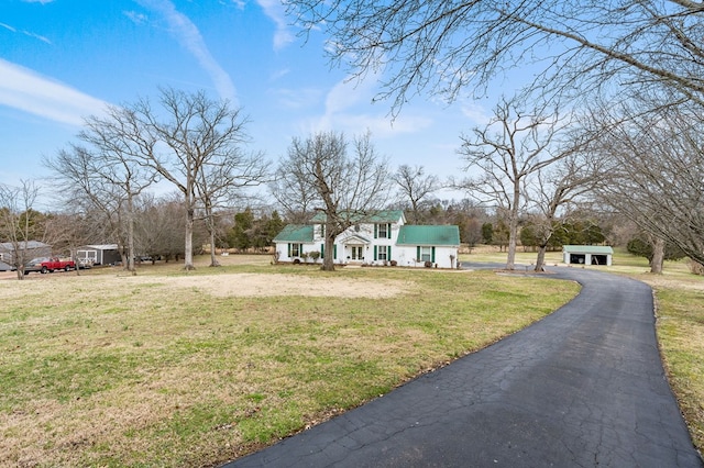 view of front of home with driveway and a front yard