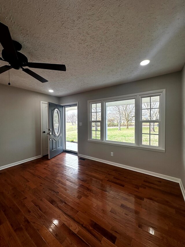 entryway featuring baseboards, a ceiling fan, dark wood-style floors, a textured ceiling, and recessed lighting