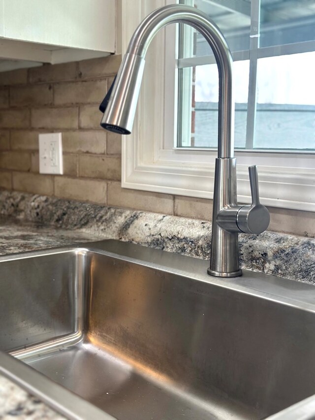 room details featuring a water view and a sink