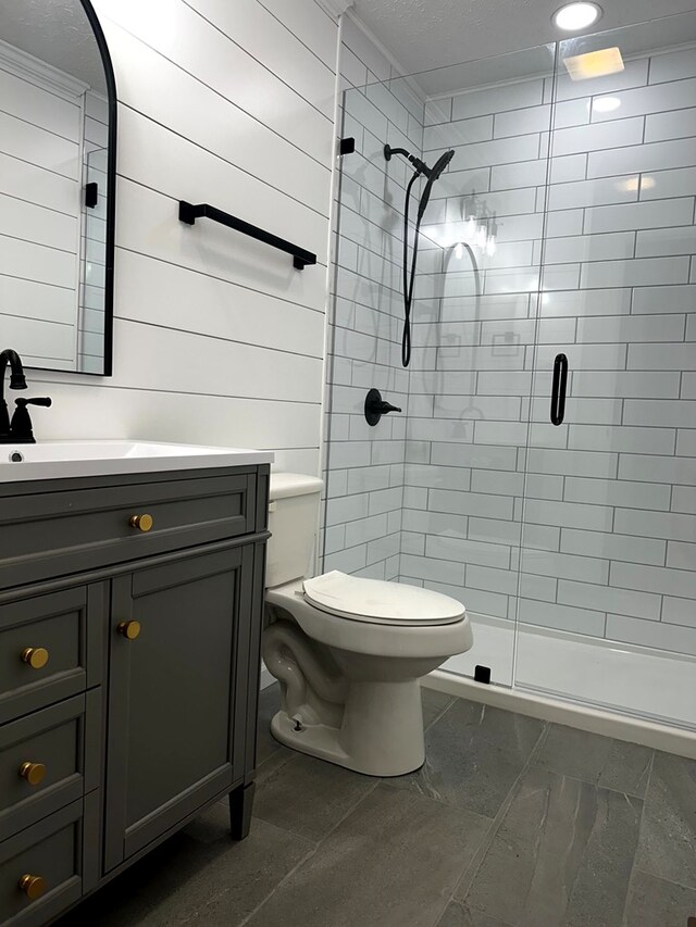 full bathroom with a stall shower, marble finish floor, vanity, and toilet