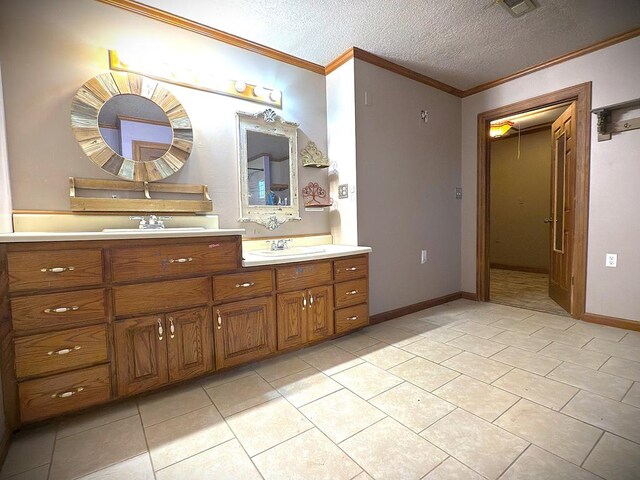 full bathroom featuring a textured ceiling, tile patterned flooring, a sink, double vanity, and crown molding