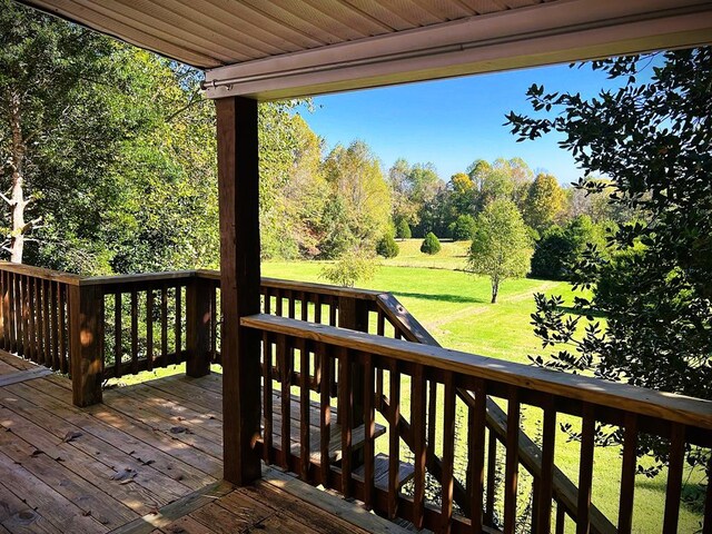 wooden deck featuring a yard