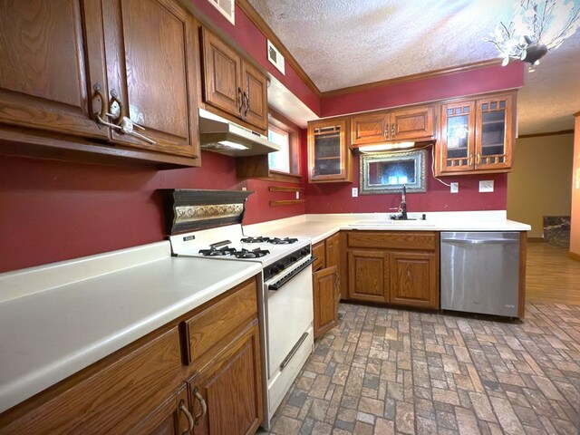 kitchen with under cabinet range hood, light countertops, stainless steel dishwasher, gas range gas stove, and glass insert cabinets