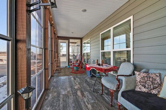 interior space with lofted ceiling, a textured ceiling, a wall mounted AC, and baseboards