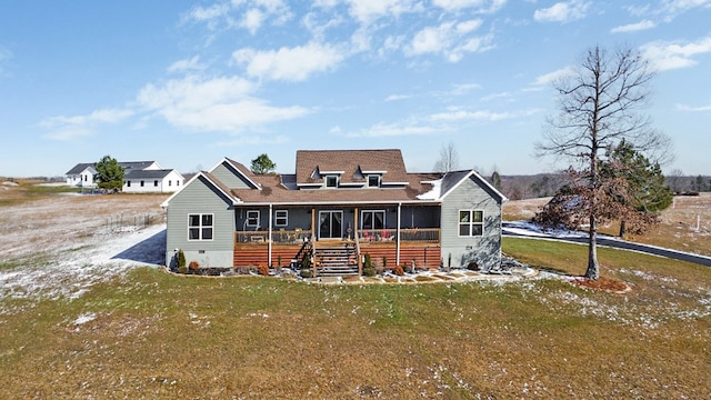 rear view of property featuring crawl space, covered porch, a lawn, and stairs