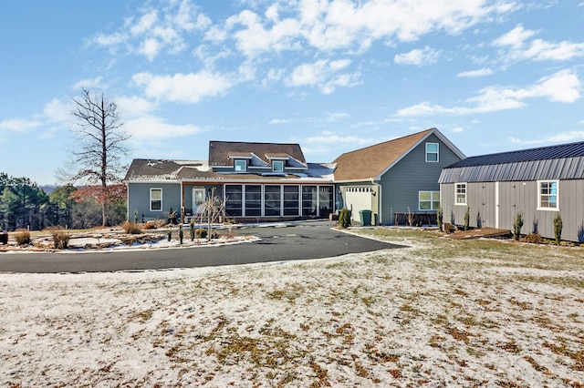 back of property featuring an attached garage and driveway