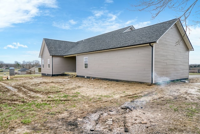 exterior space with roof with shingles