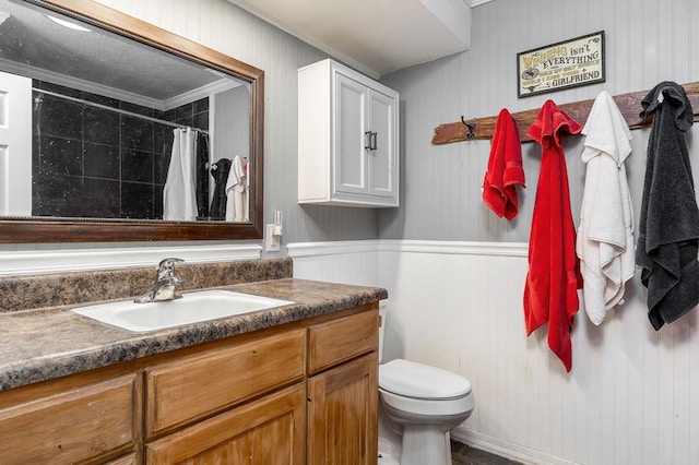 bathroom with toilet, curtained shower, ornamental molding, and vanity