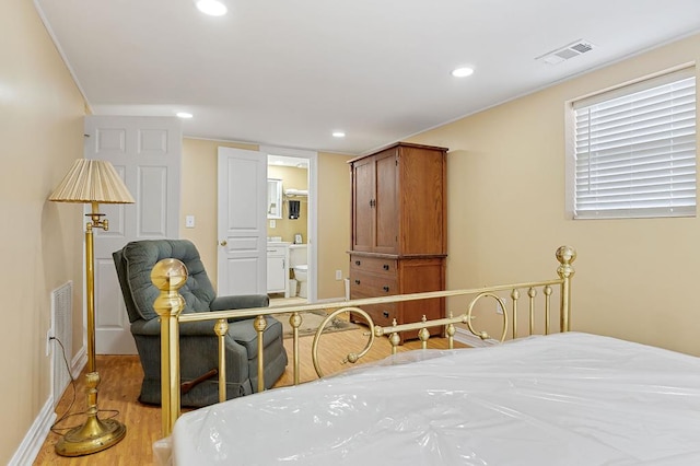 bedroom with light wood finished floors, visible vents, and recessed lighting