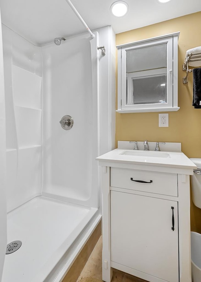 full bath featuring a shower, vanity, and toilet