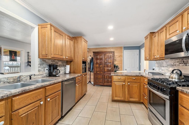 kitchen with appliances with stainless steel finishes, tasteful backsplash, a sink, and ornamental molding